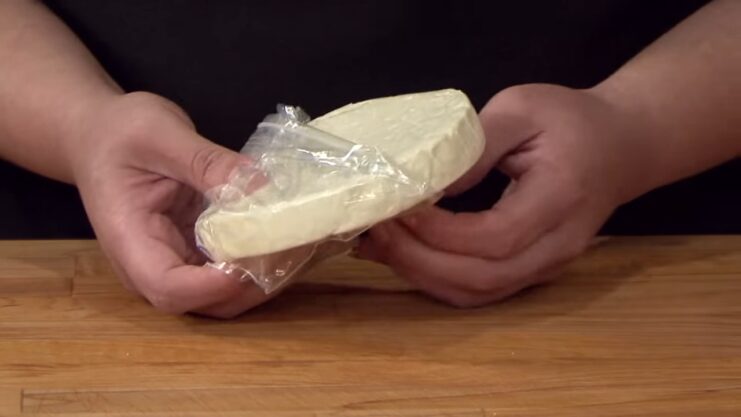 A Woman Puts Queso Fresco in A Freezer Bag